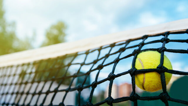 Close up photo tennis ball hitting net sport concept Close up photo tennis ball hitting net sport concept